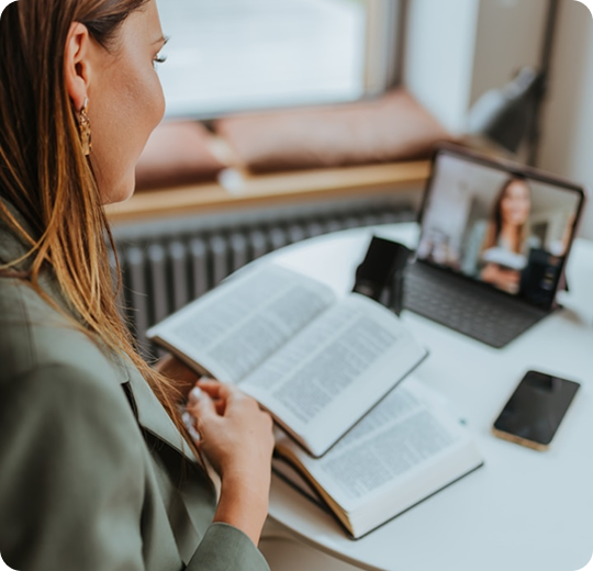 Student studying with book and laptop